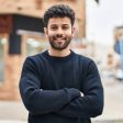 Young   man smiling confident standing with arms crossed gesture at street